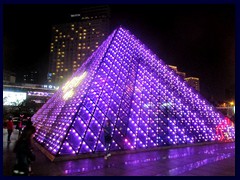 Windows of the World metro station. Inspired by the glass pyramid at the Louvre in Paris. It is illuminated and  changes colours at night.